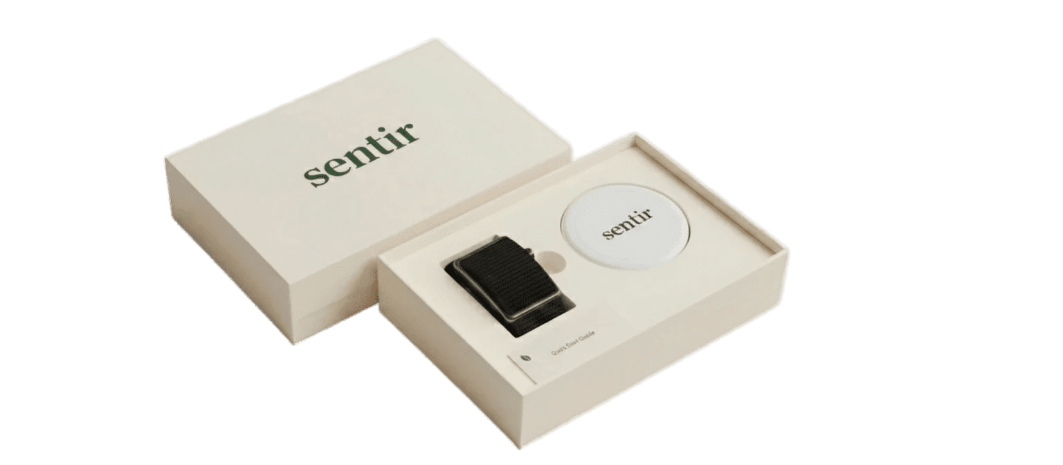 Sentir box contents — band, magnetic charging dock, and quick start guide